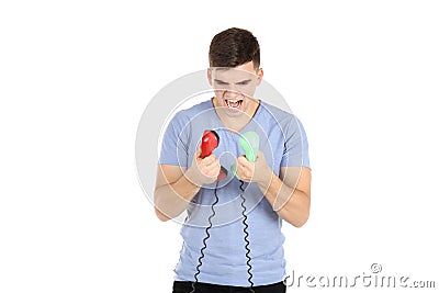 Man screaming in handsets Stock Photo