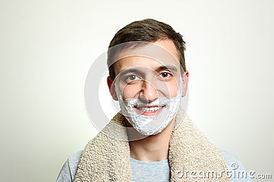 Young man with shaving foam beard smiles Stock Photo