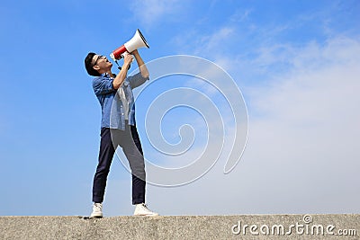 Young man shout megaphone Stock Photo