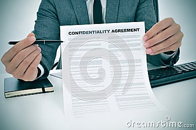 Young man showing a confidentiality agreement document Stock Photo