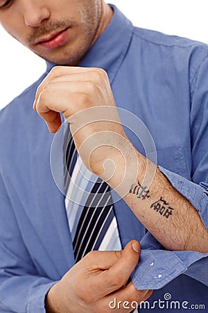 Young man showing tattoo in forearm Stock Photo