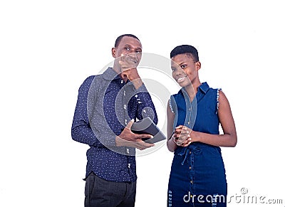 Young man showing a woman a path while pointing the finger aside Stock Photo