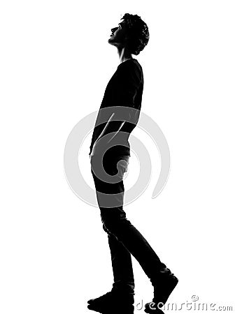 Young man silhouette walking looking up Stock Photo