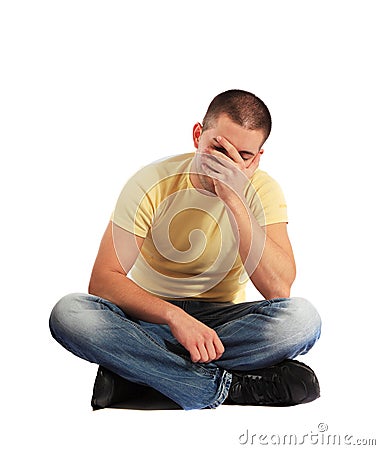 Young man sitting in desperate mood Stock Photo