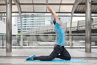 Young man sitting exercise with pose yoga meditation on blue mat Stock Photo