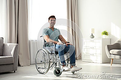 Young man sitting in modern wheelchair Stock Photo