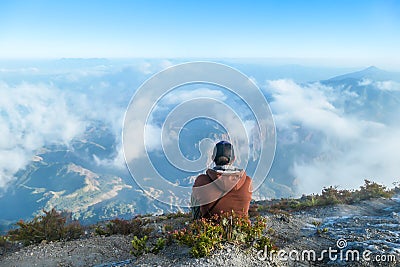 Bajawa - A man sitting on the top of the volcano, admiring the view Stock Photo