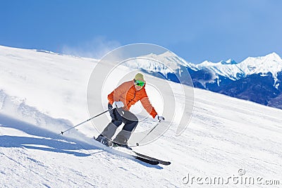 Young man in ski mask sliding fast while skiing Stock Photo