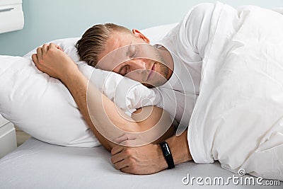 Young Man Sleeping On Bed Stock Photo