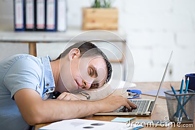 Young man sleeping on office desk Stock Photo