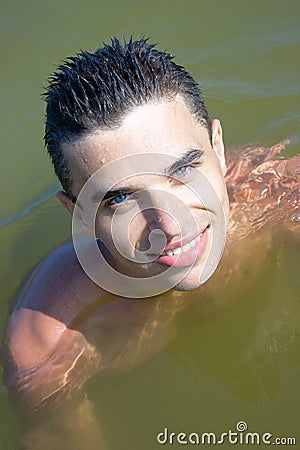 Young man smiling in the water Stock Photo