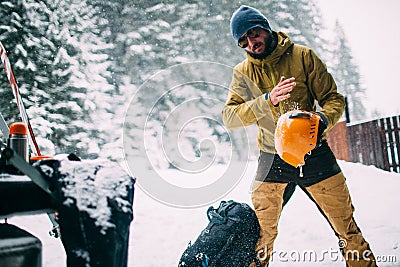 Young man in the snow forest shake off snow from helmet Stock Photo