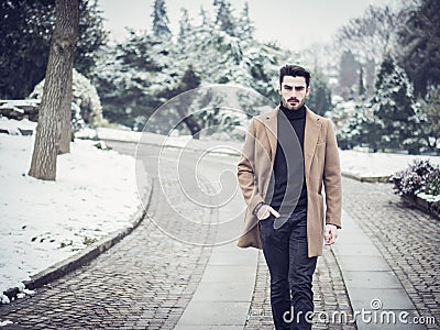 Young man in snowy city park Stock Photo