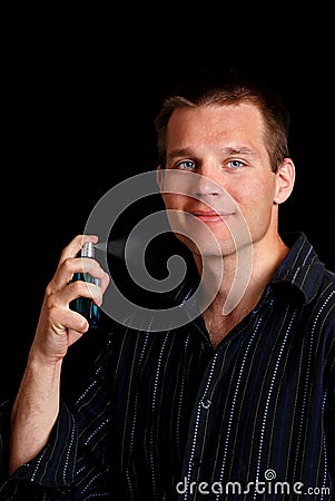 Young man spraying cologne Stock Photo