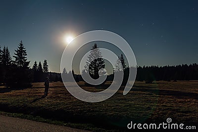 Young man stand in nice star night with trees and moon in Novohradske hory, Czech landscape Stock Photo