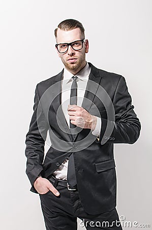 Young man standing in dark suit Stock Photo