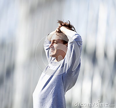 Young Man Standing Feeling Happy Stock Photo