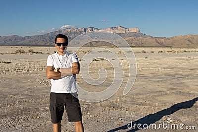 Young man standing in front of Guadalupe Peak, El Capitan Stock Photo