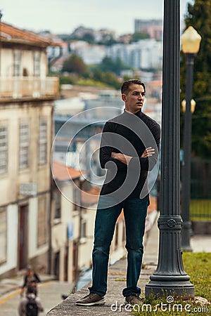 Young man standing on the street in old european downtown. Travel. Stock Photo