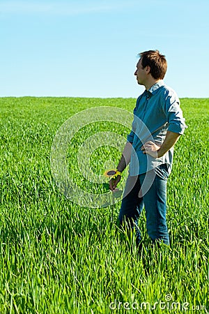 Young man standing with a sunflower Stock Photo