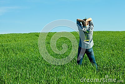 Young man standing with a sunflower Stock Photo