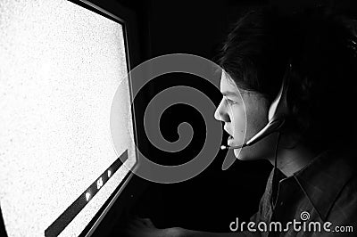 Young man staring into static TV Computer screen Stock Photo