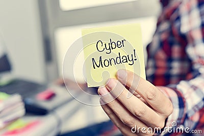 Young man with a sticky note with the text cyber monday Stock Photo