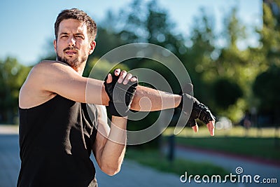 Young man stretching after the workout Stock Photo