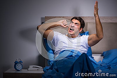 The young man struggling from noise in bed Stock Photo