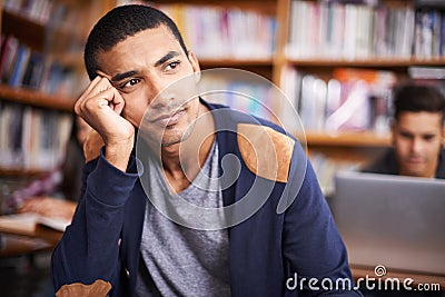 Young man, student and thinking of education in library and knowledge for exam in university. Scholarship, idea and Stock Photo