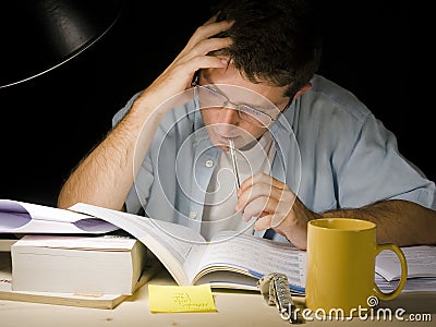 Young Man Studying at Night Stock Photo