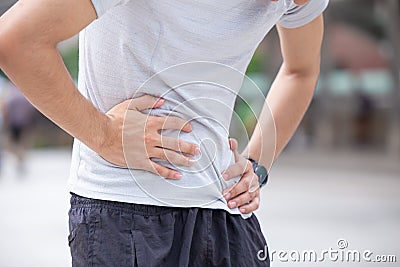 Young man suffering from gastritis abdominal pain due to flatulence diarrhea or acidosis Stock Photo
