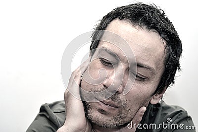 Young man suffering from toothache, teeth pain, having a swollen Stock Photo