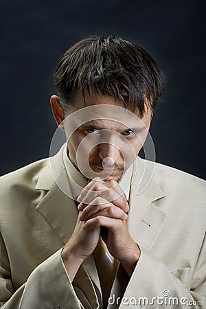 Young man in a suit, praying for something Stock Photo