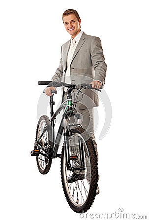 Young man in a suit standing next to a bike Stock Photo