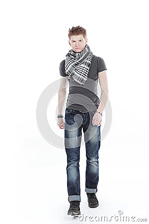 Young man in a t-shirt and scarf ,confidently goes forward. Stock Photo