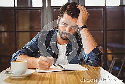 Young man taking notes in his notebook Stock Photo