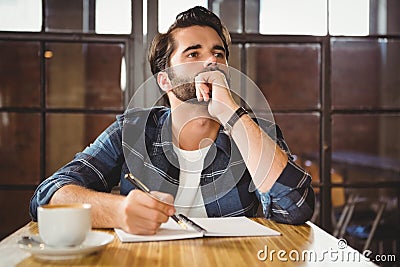 Young man taking notes in his notebook Stock Photo