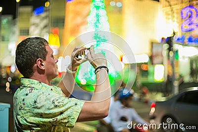 Young man taking picture on his mobile phone Editorial Stock Photo