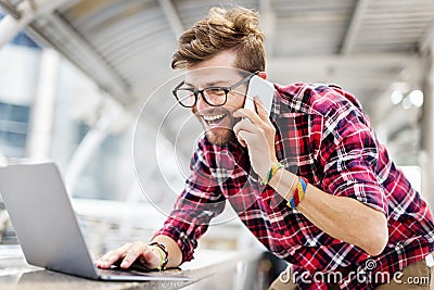 Young Man Talking Smartphone Browsing Laptop Concept Stock Photo