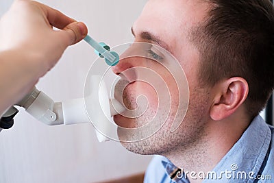 Young man testing breathing function by spirometry Stock Photo