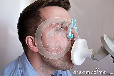 Young man testing breathing function by spirometry Stock Photo