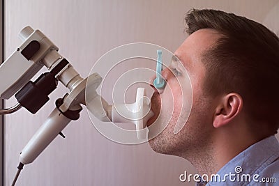 Young man testing breathing function by spirometry Stock Photo