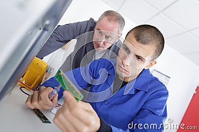 Young man testing computer component Stock Photo