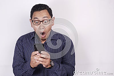 Young Man Texting Reading Chatting on His Phone Surprised Gesture Stock Photo