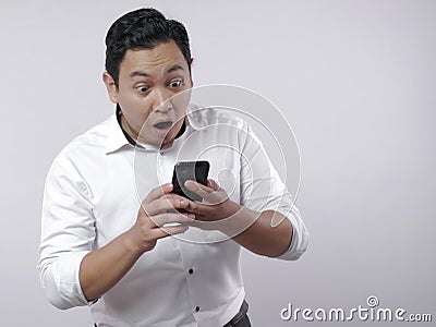 Young Man Texting Reading Chatting on His Phone Surprised Gesture Stock Photo
