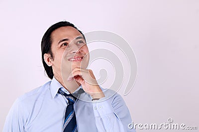 Young Man Thinking and Looking Up, Having Good Idea Stock Photo