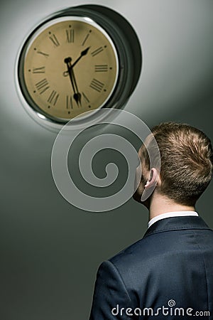 Young man and ticking clock Stock Photo