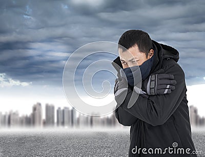 Young man tightening body in outdoors cold weather Stock Photo