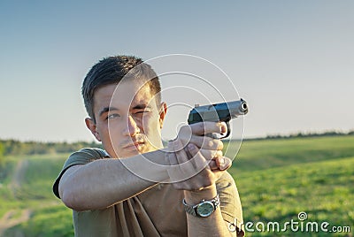 Young man took aim with pistol Stock Photo